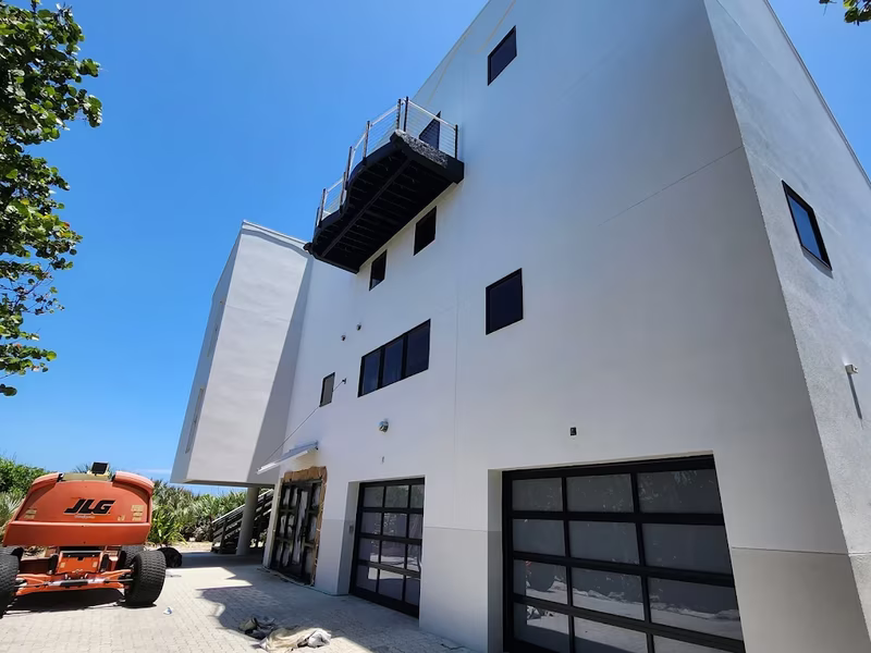 Modern commercial building exterior painting with boom lift by RPB Painting Florida