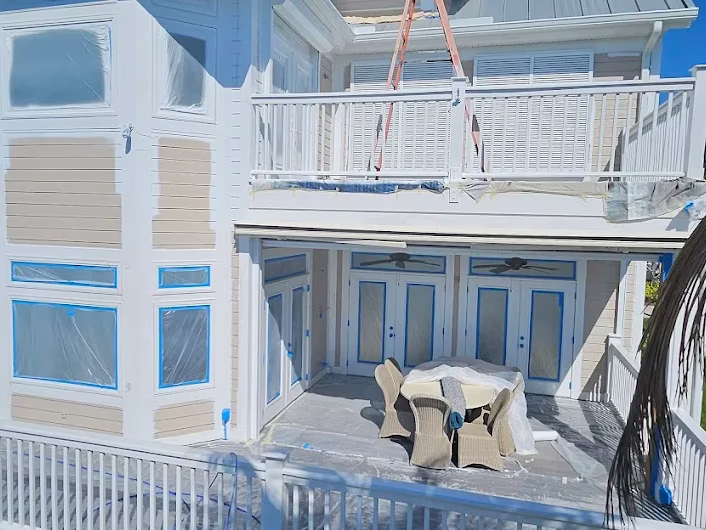 Coastal beach house exterior painting in progress with boom lift by RPB Painting