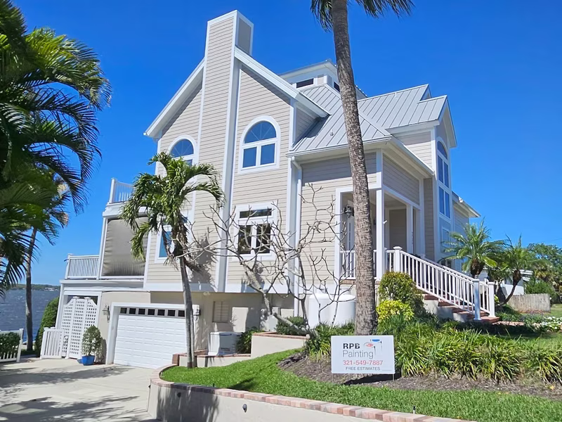 Gray coastal two-story home exterior painting by RPB Painting Florida