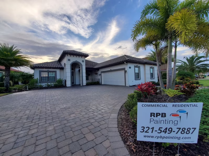 Luxury home exterior painting with paver driveway at sunset by RPB Painting