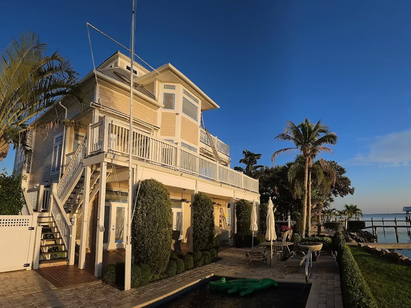 Waterfront home exterior painting at sunset by RPB Painting Florida